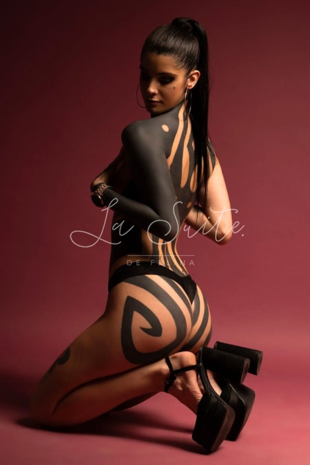 Tattooed luxury escort in black lingerie and high heels at Felina Valencia, Renata
